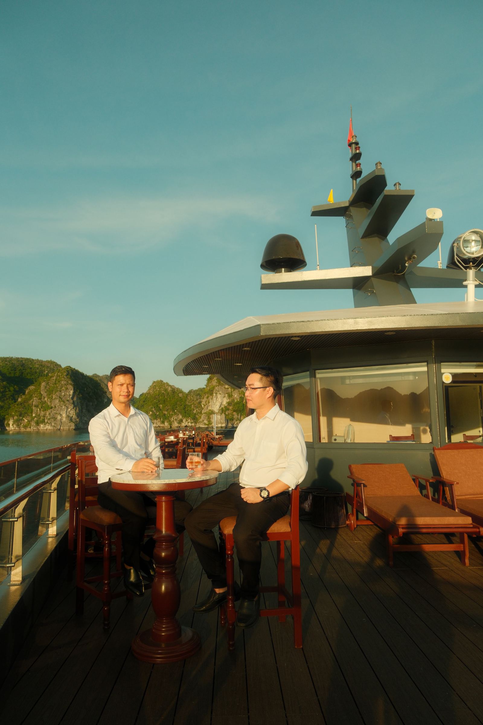 Friends relaxing on the top deck taking in the bay
